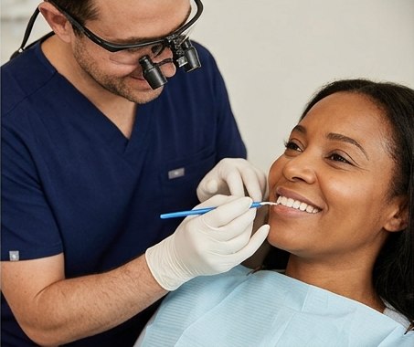Cosmetic dentist carefully applying composite bonding